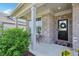 Charming front porch features brick accents, a welcoming wreath, and a cozy welcome mat at 9671 Ridgecrest Ln, McCordsville, IN 46055