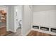 Mudroom with a built-in bench, storage cubbies, and an adjacent half bathroom at 9671 Ridgecrest Ln, McCordsville, IN 46055