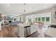 Open concept kitchen with island seating flows into the dining and living area at 9671 Ridgecrest Ln, McCordsville, IN 46055