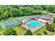 An aerial view showcases the community's tennis courts, basketball court, and large pool at 1000 Leisure Ln, Greenwood, IN 46142