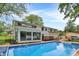 Spacious backyard featuring an inground pool, sun room, and a white exterior at 1000 Leisure Ln, Greenwood, IN 46142