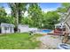 Enjoy a spacious backyard featuring a sparkling pool, playhouse, garage, deck, and fire pit for relaxation and entertainment at 1000 Leisure Ln, Greenwood, IN 46142