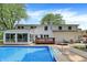 Expansive backyard featuring an inviting in-ground pool, a well-maintained deck, and a cozy sunroom at 1000 Leisure Ln, Greenwood, IN 46142