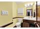 Bathroom showcasing a vanity with wood accents and modern fixtures, along with a toilet and storage cabinet at 1000 Leisure Ln, Greenwood, IN 46142
