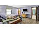 This bedroom features comfortable carpet, purple walls, and includes a dresser with a fan and a wall-mounted television at 1000 Leisure Ln, Greenwood, IN 46142