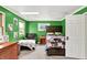 This bedroom features green walls, carpet, a comfortable recliner, and two twin-sized beds at 1000 Leisure Ln, Greenwood, IN 46142