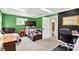 This bedroom features green walls, carpet, and an office area at 1000 Leisure Ln, Greenwood, IN 46142