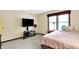 Inviting bedroom features a mounted TV, bedside tables, and large window for natural light at 1000 Leisure Ln, Greenwood, IN 46142