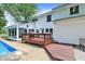 The backyard has a wood deck, offering an ideal space for outdoor dining and relaxation by the pool at 1000 Leisure Ln, Greenwood, IN 46142