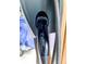 Tesla electric vehicle charger with a black charging cord shown at 1000 Leisure Ln, Greenwood, IN 46142