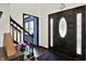 Entryway with dark wood door, leaded glass, and hardwood floors at 1000 Leisure Ln, Greenwood, IN 46142