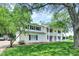 Side view of charming two-story white home with black shutters and well-manicured green lawn at 1000 Leisure Ln, Greenwood, IN 46142