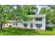 Charming two-story home with a classic facade, a red front door, and a lush green lawn at 1000 Leisure Ln, Greenwood, IN 46142