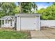 View of a garage and a playhouse in the backyard, adding storage and fun to the outdoor space at 1000 Leisure Ln, Greenwood, IN 46142