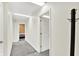 Bright hallway with white walls and grey carpet featuring multiple doorways to other rooms at 1000 Leisure Ln, Greenwood, IN 46142