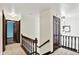Hallway with carpeted flooring, white walls, and dark stained trim and doors at 1000 Leisure Ln, Greenwood, IN 46142