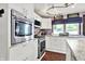 Modern kitchen featuring stainless steel appliances, granite countertops, and white cabinets at 1000 Leisure Ln, Greenwood, IN 46142
