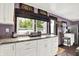 Bright kitchen with granite countertops, white cabinetry, and stainless steel appliances and a door to a deck at 1000 Leisure Ln, Greenwood, IN 46142