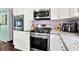 Modern kitchen featuring stainless steel appliances, granite countertops, and white cabinets at 1000 Leisure Ln, Greenwood, IN 46142