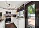 Bright kitchen with stainless steel appliances, granite countertops and white cabinets, leading to the backyard deck at 1000 Leisure Ln, Greenwood, IN 46142
