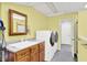 Functional laundry room with washer, dryer, sink, and storage, ideal for efficient household chores at 1000 Leisure Ln, Greenwood, IN 46142