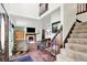 Open concept living room with fireplace, stairs, and view to the kitchen at 1000 Leisure Ln, Greenwood, IN 46142