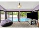 Living room offering an indoor-outdoor flow to the pool, carpet flooring, and vaulted ceilings at 1000 Leisure Ln, Greenwood, IN 46142
