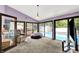 A bright living room with large glass doors offers views of the pool and backyard at 1000 Leisure Ln, Greenwood, IN 46142