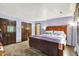 Main bedroom with carpet flooring, natural light, and double door closet storage at 1000 Leisure Ln, Greenwood, IN 46142