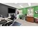 Bright office with desk, shelving, and wall-mounted television at 1000 Leisure Ln, Greenwood, IN 46142