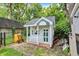 Charming playhouse with a porch and detailed trim, offering a delightful space for outdoor adventures at 1000 Leisure Ln, Greenwood, IN 46142