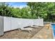 Relaxing pool area with two sun loungers and a white fence for privacy at 1000 Leisure Ln, Greenwood, IN 46142