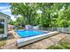 In-ground pool with a pool cover system and mature trees creating a peaceful backyard setting at 1000 Leisure Ln, Greenwood, IN 46142