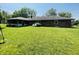 Spacious backyard with a well-maintained lawn, a brick house, and plenty of space at 1008 Whispering Trl, Greenfield, IN 46140