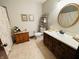 Well-maintained bathroom featuring a single sink vanity, decorative mirror, and tiled flooring at 1008 Whispering Trl, Greenfield, IN 46140