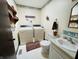 A combined laundry room and bathroom with white appliances at 1008 Whispering Trl, Greenfield, IN 46140