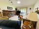 Cozy living room with brick fireplace, plush seating, and plenty of natural light at 1008 Whispering Trl, Greenfield, IN 46140