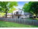 Charming stone home featuring a wooden fence and private balcony overlooking a lush, green backyard at 1031 Lancashire Ln, Pendleton, IN 46064