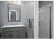 Modern bathroom featuring a gray vanity with a white countertop and a glass-enclosed shower at 1031 Lancashire Ln, Pendleton, IN 46064
