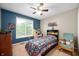 Comfortable bedroom with a ceiling fan, large window, and decorated walls at 1031 Lancashire Ln, Pendleton, IN 46064