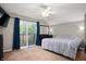 Spacious bedroom featuring a ceiling fan, a sliding glass door to the deck, and neutral paint colors at 1031 Lancashire Ln, Pendleton, IN 46064