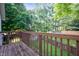 A wooden deck overlooking a large backyard with mature trees and a lush green lawn at 1031 Lancashire Ln, Pendleton, IN 46064