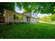 Landscaped front yard showcasing a stone facade and large picture window at 1031 Lancashire Ln, Pendleton, IN 46064