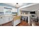 Open kitchen with stainless steel appliances, light countertops, and an adjacent breakfast bar at 1031 Lancashire Ln, Pendleton, IN 46064