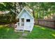 Adorable playhouse with a charming design and fenced-in yard, perfect for outdoor fun and imaginative play at 1031 Lancashire Ln, Pendleton, IN 46064