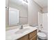 Bathroom featuring a wood vanity, large mirror, and shower-tub combination at 10668 Whippoorwill Ln, Indianapolis, IN 46231