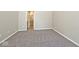 Bedroom featuring gray carpet and neutral paint, with a bathroom visible at 10668 Whippoorwill Ln, Indianapolis, IN 46231