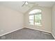 Cozy bedroom with vaulted ceiling and large arched window at 10668 Whippoorwill Ln, Indianapolis, IN 46231