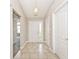 Inviting foyer featuring neutral walls, tile flooring, and decorative lighting fixture at 10668 Whippoorwill Ln, Indianapolis, IN 46231