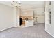Bright open-concept living room with vaulted ceilings leading into adjacent kitchen space at 10668 Whippoorwill Ln, Indianapolis, IN 46231